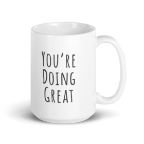 Tall white mug that says "You're Doing Great"