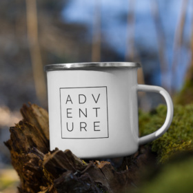 White enamel mug with ADVENTURE boxed design 12oz handle on right in a tree