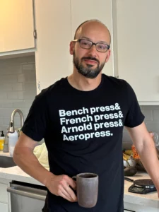 Happy WRDMRK customer wearing custom ampersand t-shirt and drinking coffee